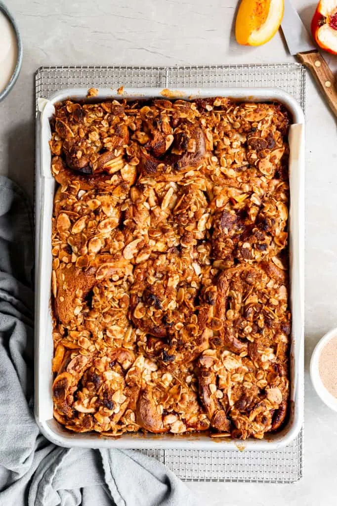 Bake tray of cinnamon rolls fresh from the oven on a cooling rack