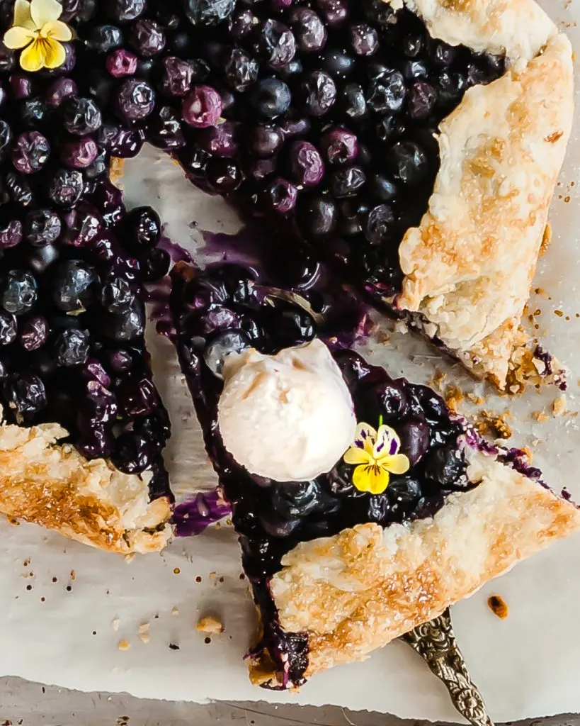 Vegan Blueberry Ginger Galette sliced and served with vegan ice cream