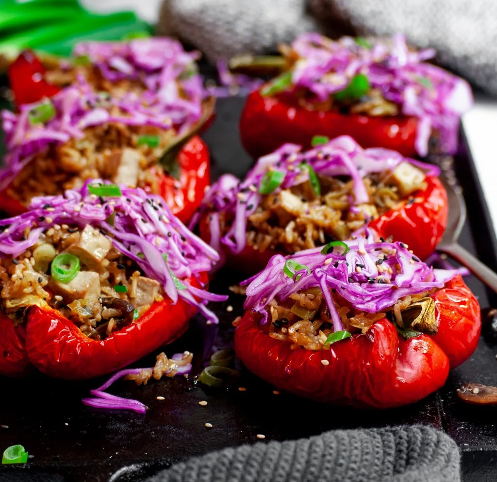 Roasted Peppers Stuffed with Sesame Ginger Mushrooms, Tofu and Rice, Topped with Red Cabbage Slaw