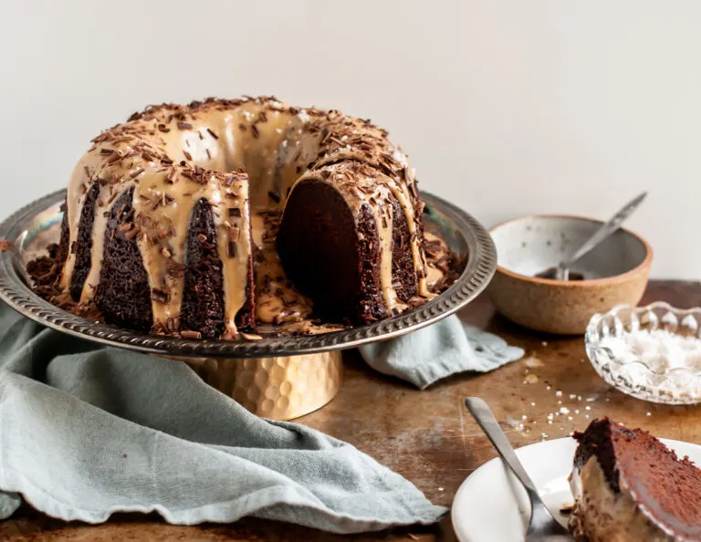 Vegan Chocolate Bundt Cake with Salted Peanut Butter Glaze sliced and being served
