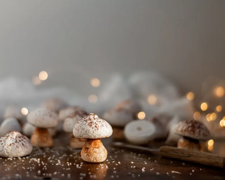 Vegan Meringue Mushroom surrounded by some partly assembled mushrooms