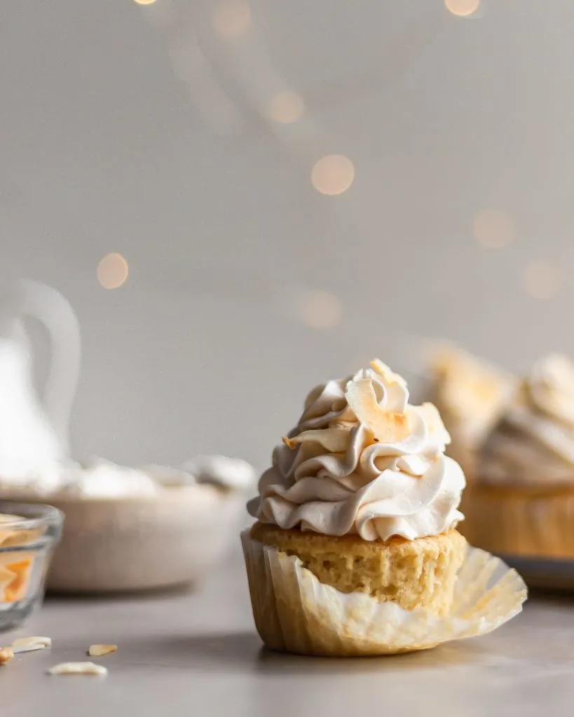 Vegan Coconut Cream Cupcake with the cupcake liner being removed