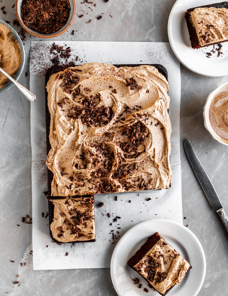 Vegan Chocolate Cake with Fluffy Espresso Frosting slced and served with coffee