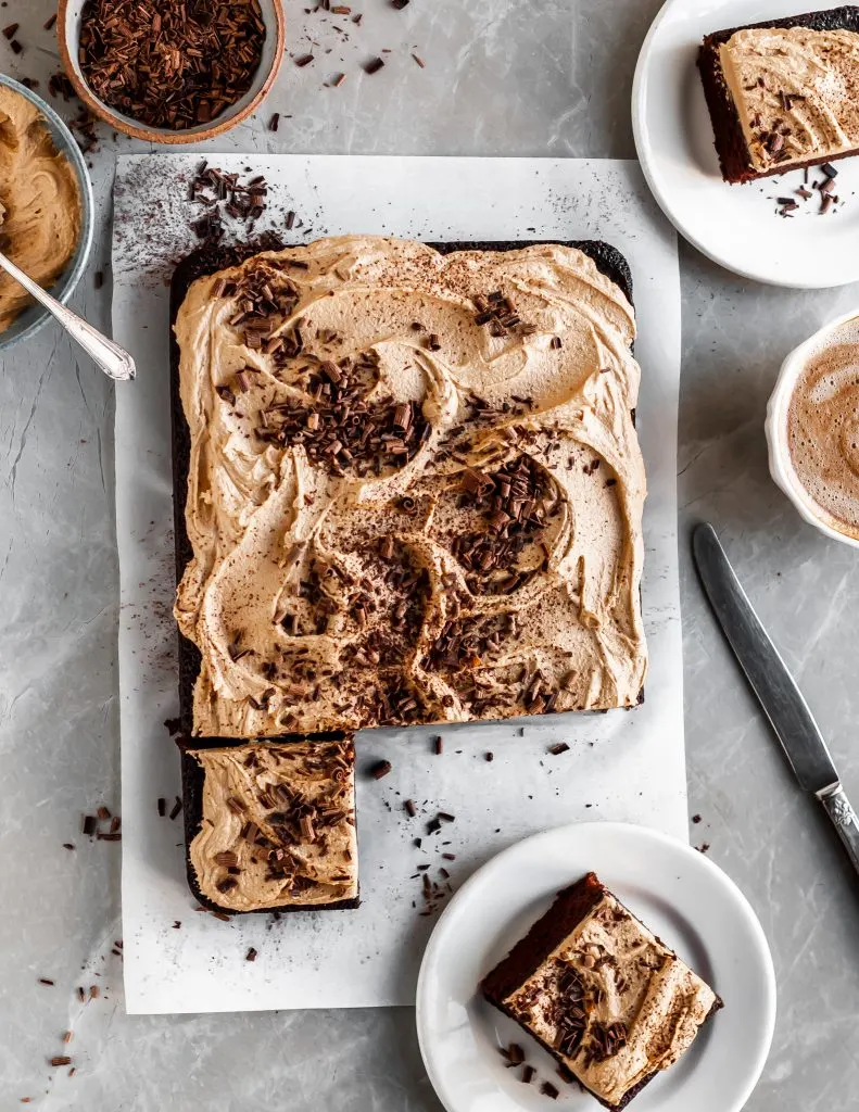 Vegan Chocolate Cake with Fluffy Espresso Frosting slced and served with coffee