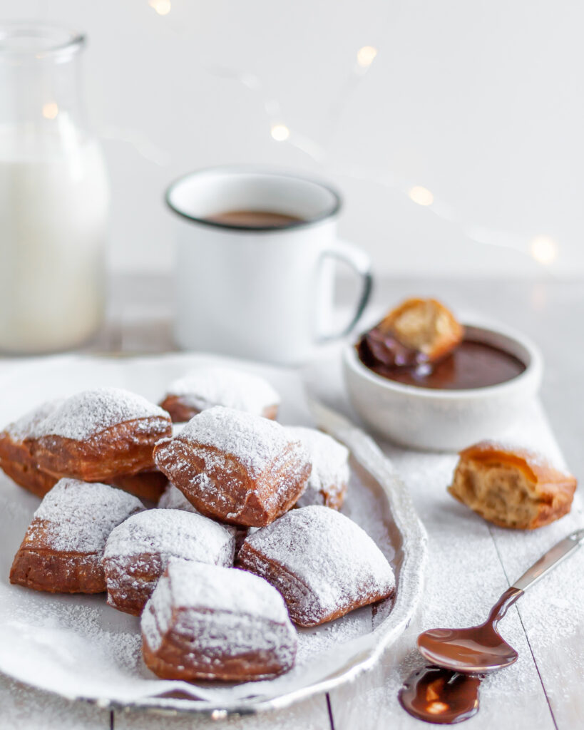 Fresh Vegan Beignets served with powdered sugar, chocolate sauce and coffee