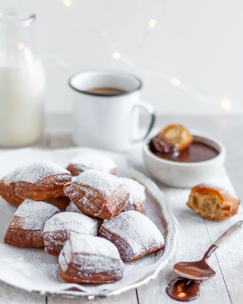 Fresh Vegan Beignets served with powdered sugar, chocolate sauce and coffee