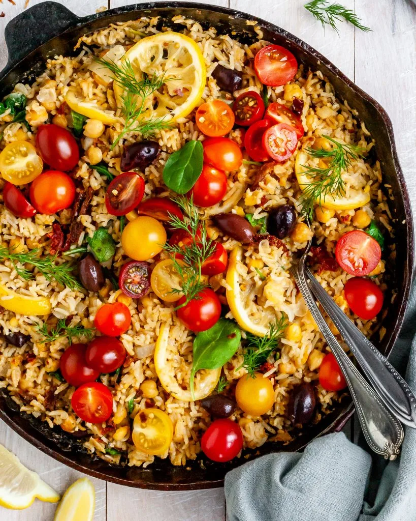 One-Skillet Baked Greek Lemon Chickpeas and Rice fresh out of the oven garnished wth fresh dill