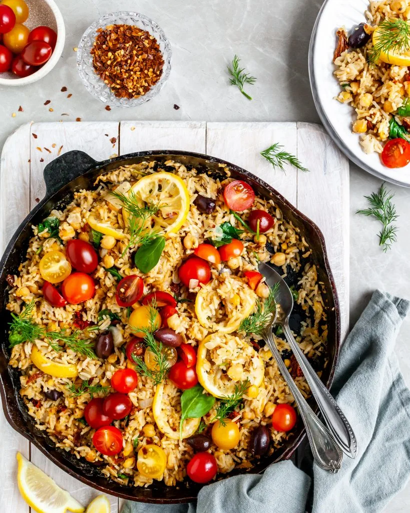 One-Skillet Baked Greek Lemon Chickpeas and Rice being served on white plates