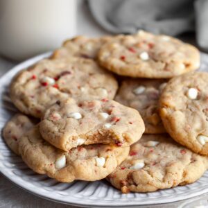 Vegan Strawberries & Cream Chewy Cookies on a plate with a bite taken out of one revealing the chewy interior