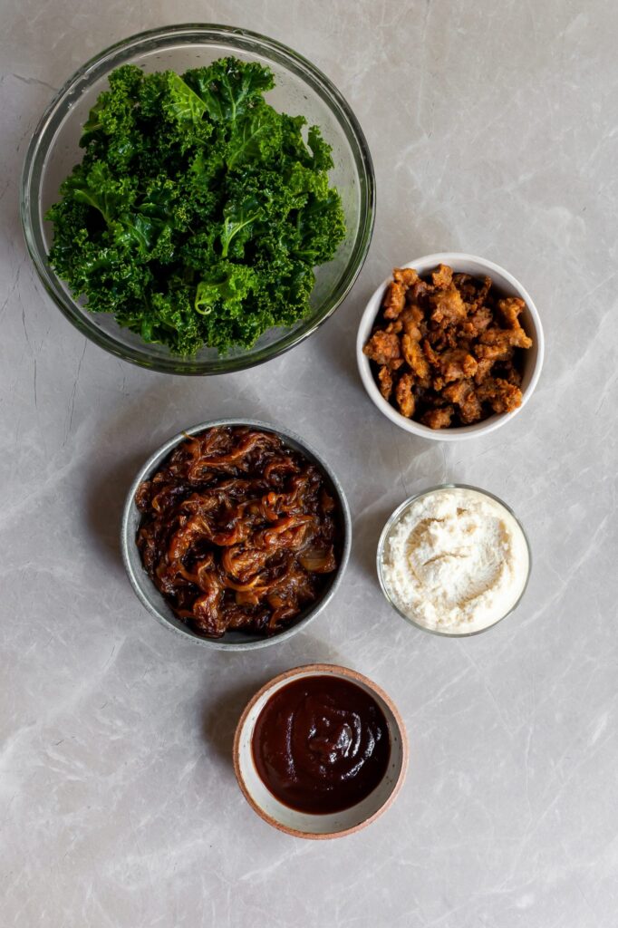 Toppings for the pizza laid out on bowls