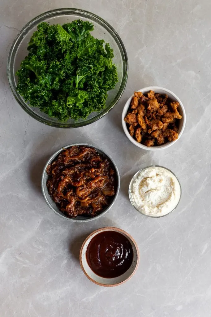 Toppings for the pizza laid out on bowls