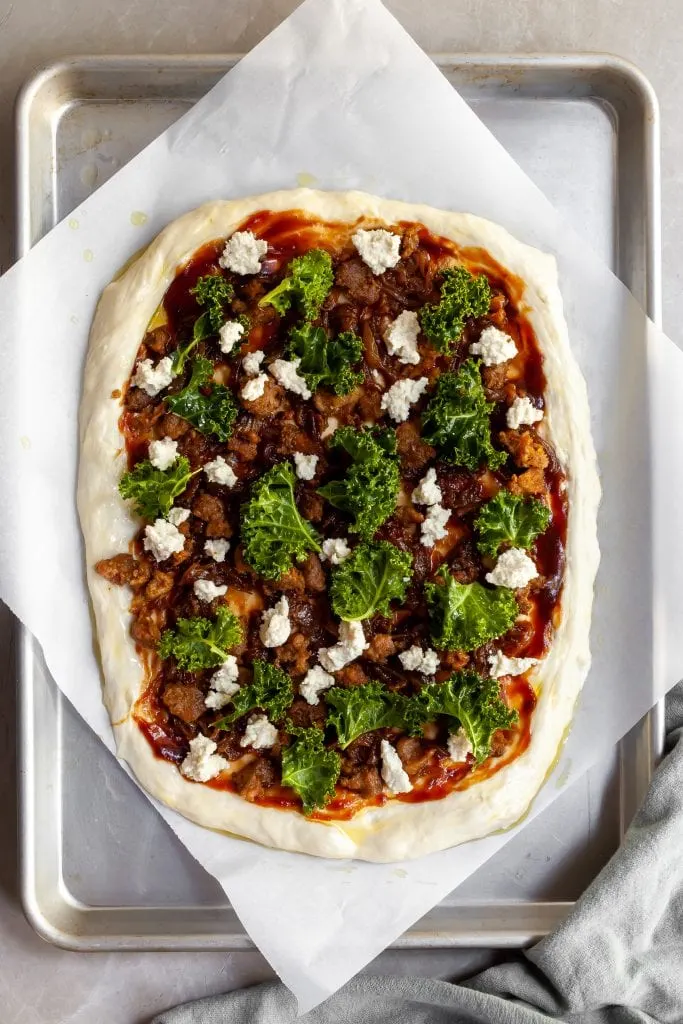 Flatlay of the assembled pizza before being baked.