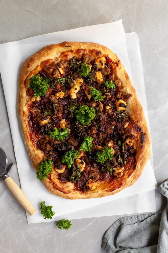 Flaylay of the pizza fresh from the oven and some fresh kale sprinkled on top