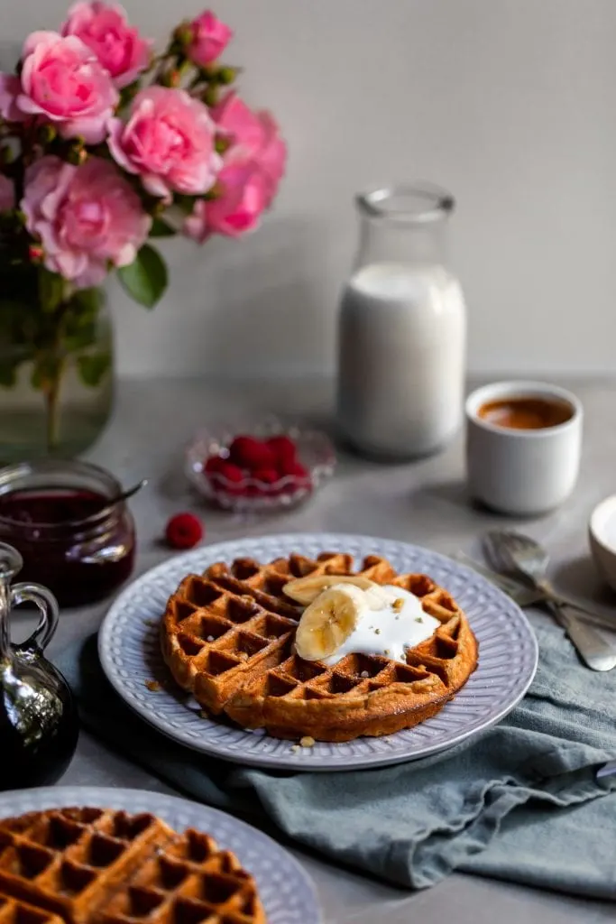 Vegan Banana Waffles served with vegan cream and fresh bananas