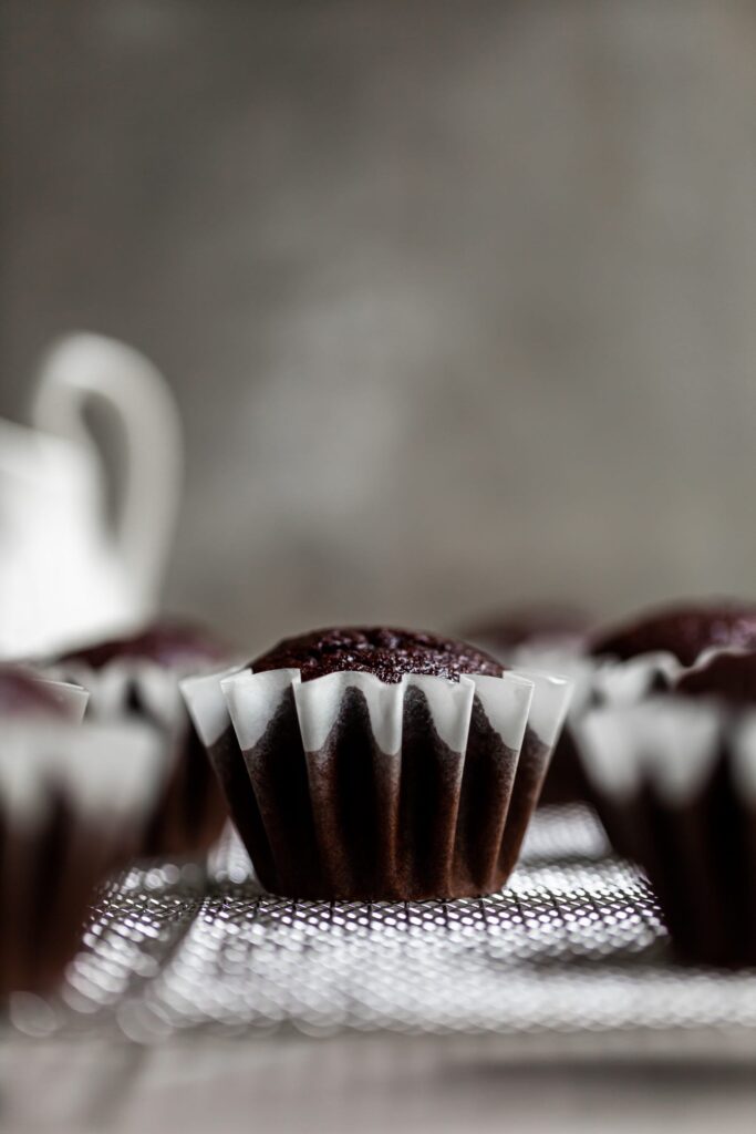 Close up of a single unfrosted cupcake base in a frilly cupcake liner