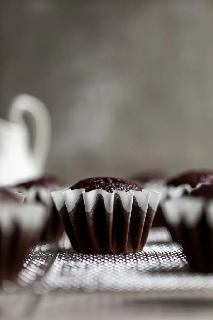 Close up of a single unfrosted cupcake base in a frilly cupcake liner
