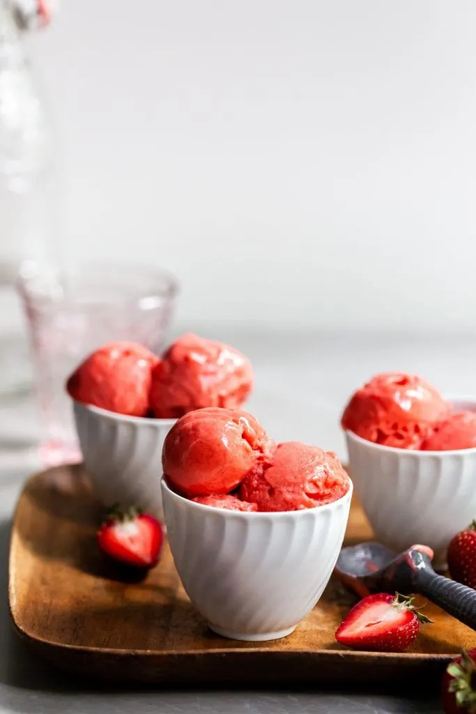 3 small white bowls with scoops of strawberry rhubarb sorbet