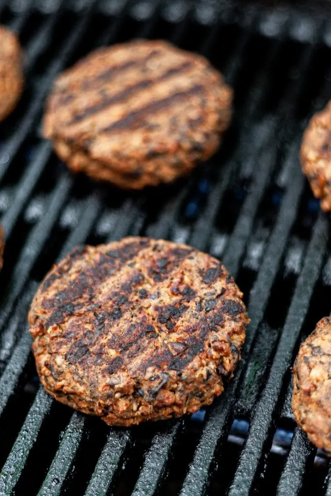 Veggie patties flipped on grill showing char marks