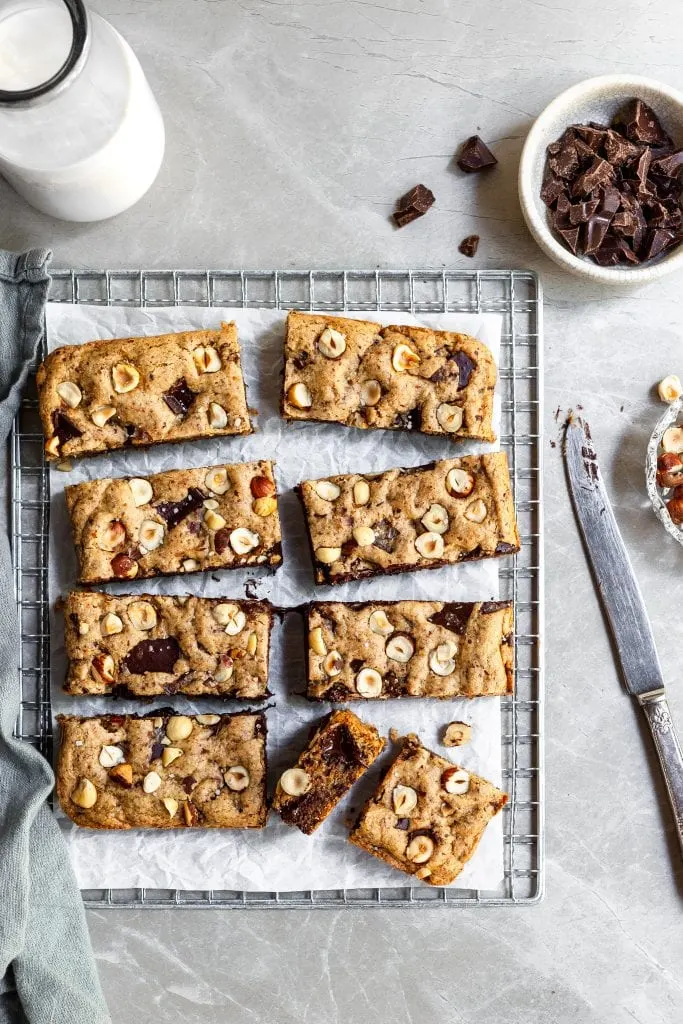 Chocolate Chunk Blondies cut into 7 rectangles and 2 squares on a cooling rack