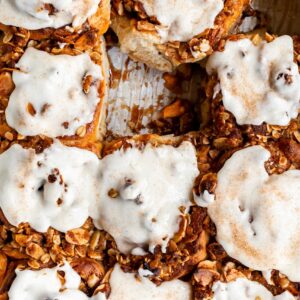 Close up of glazed cinnamon rolls in a pan