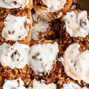 Close up of glazed cinnamon rolls in a pan