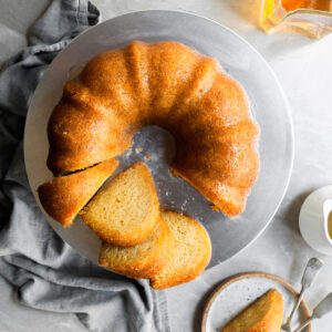 Top down view of rum cake with 4 slices cut