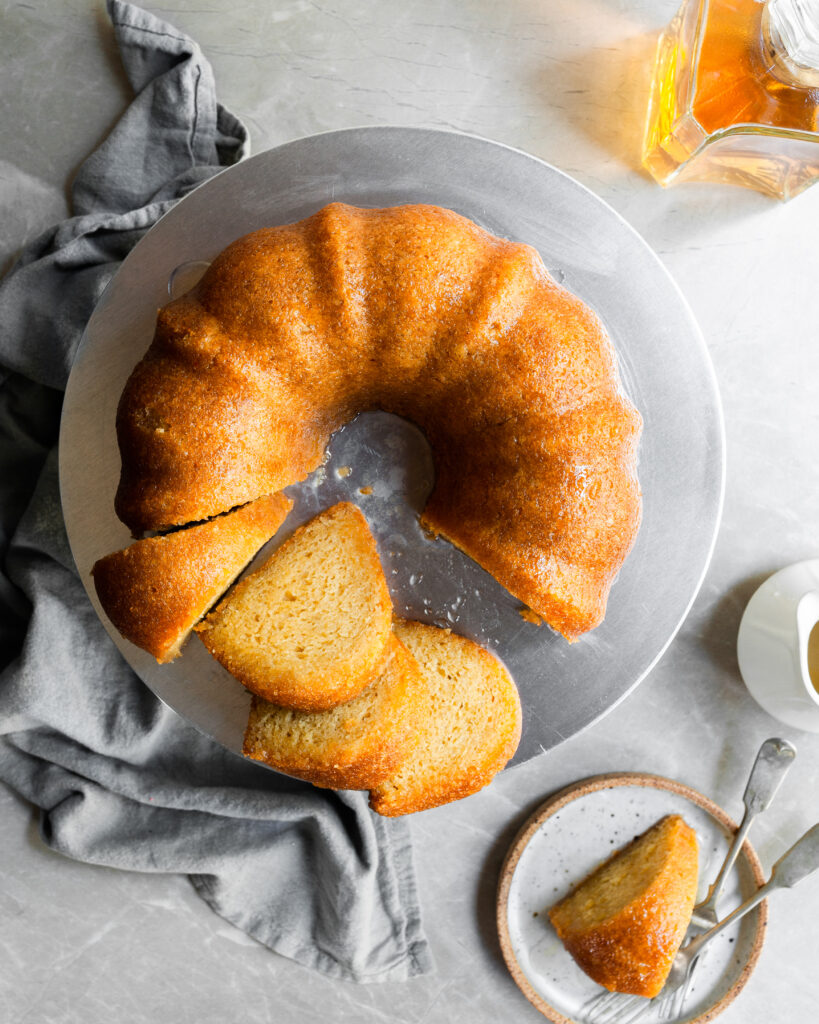 Top down view of rum cake with 4 slices cut