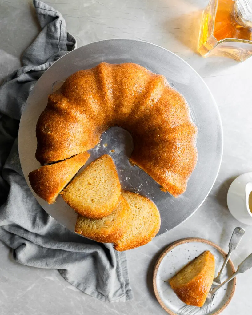 Top down view of rum cake with 4 slices cut