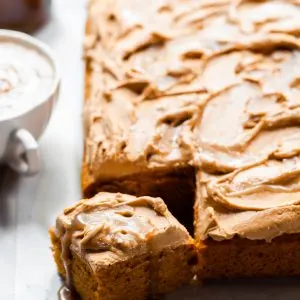 Sheet cake with swirled frosting served with a pumpkin spice latte and butterscotch sauce