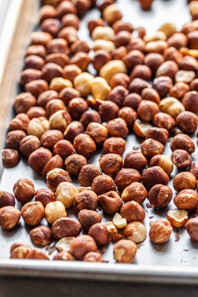 Whole hazlenuts on a baking sheet