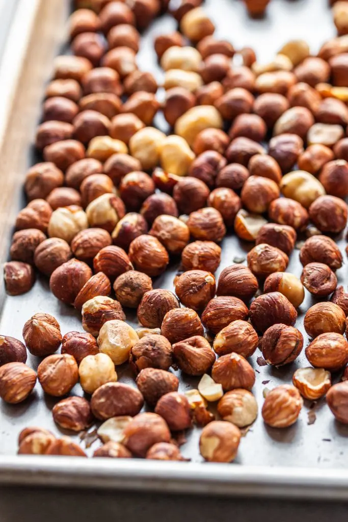 Whole hazlenuts on a baking sheet