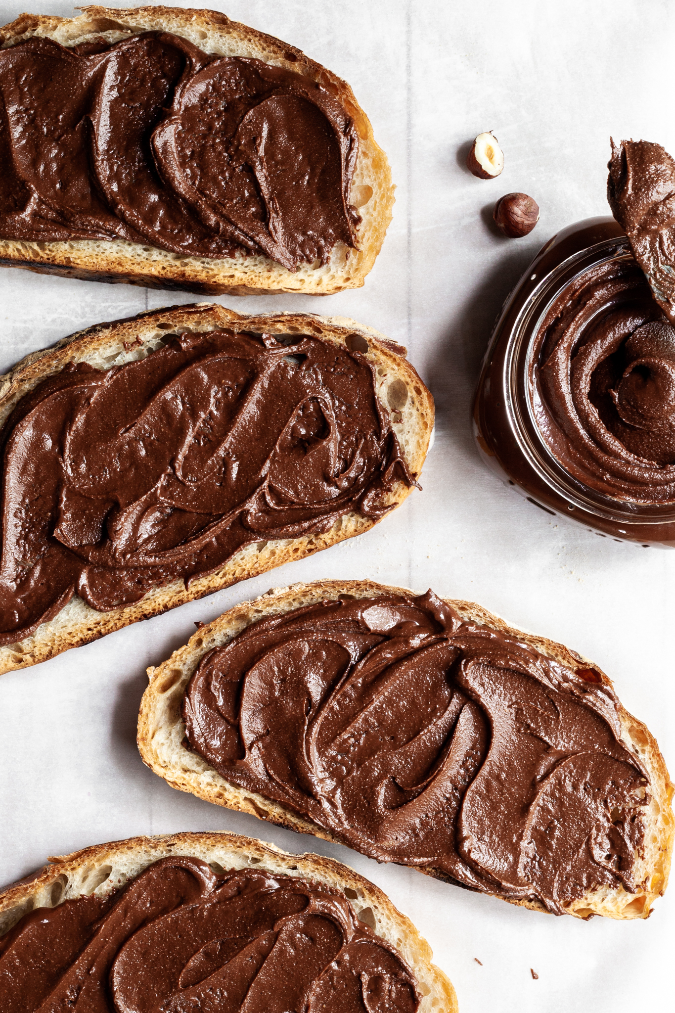 4 slices of bread spread with homemade chocolate hazelnut spread