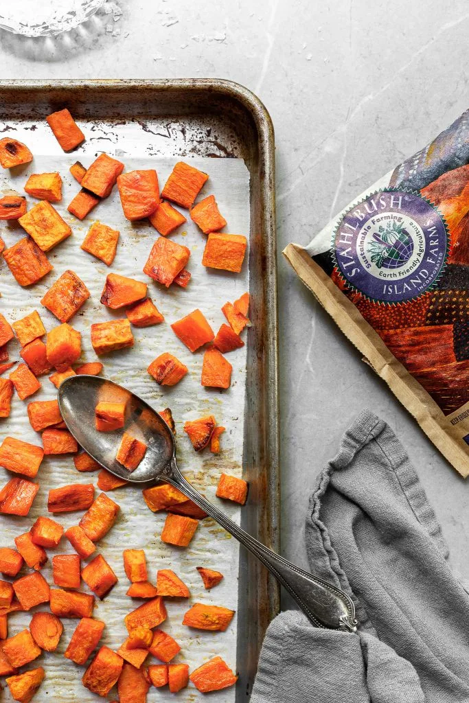Baking sheet filled with roasted sweet potatoes