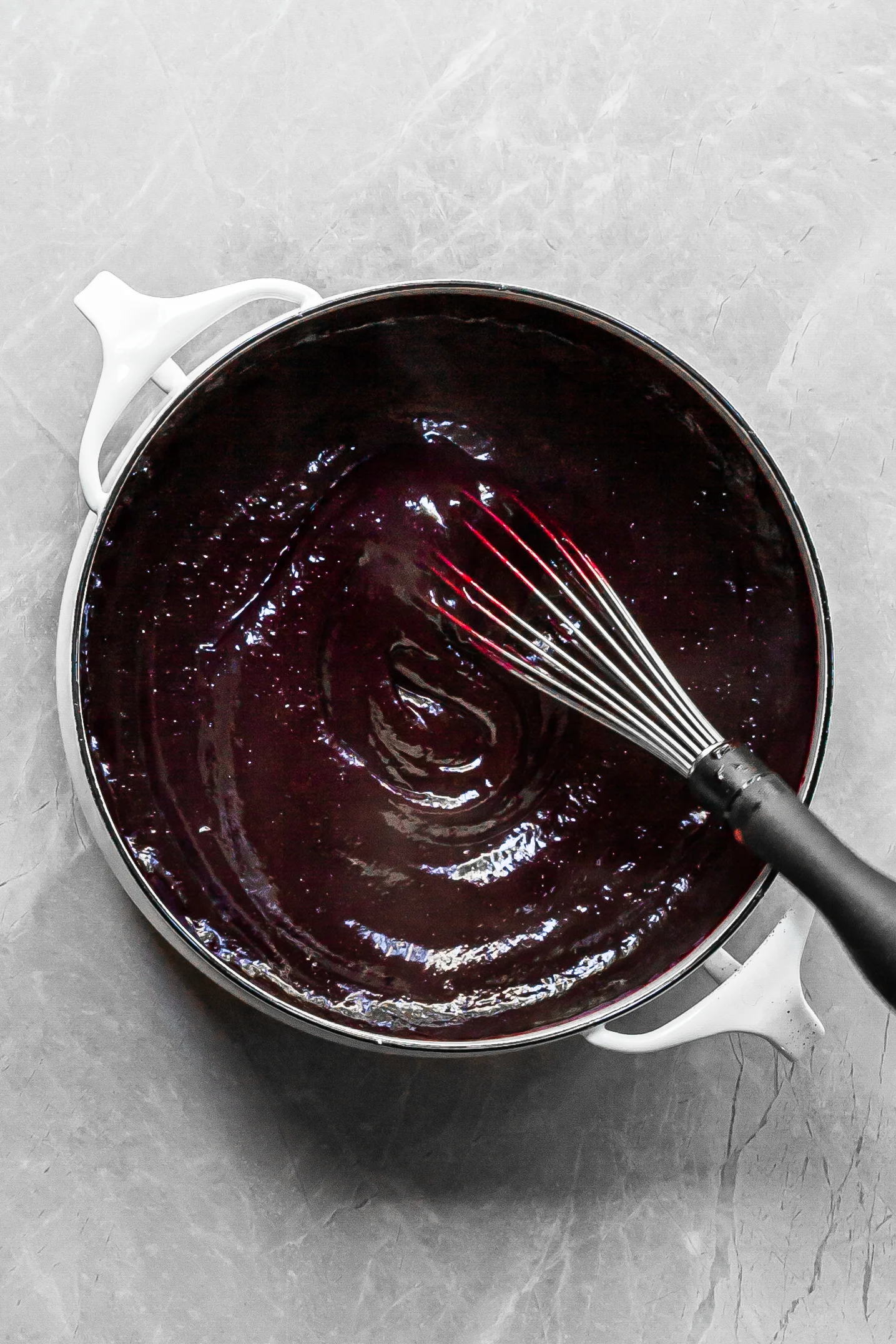 White pot filled with purple berry curd