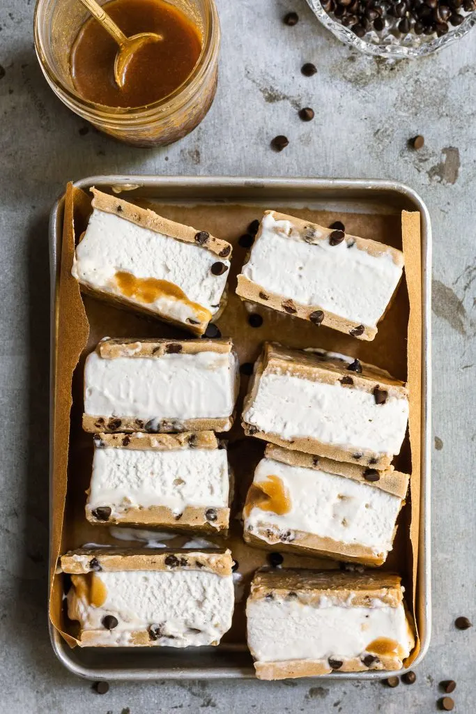 A rectangular aluminium tray filled with chocolate chip cookie dough ice cream sandwiches