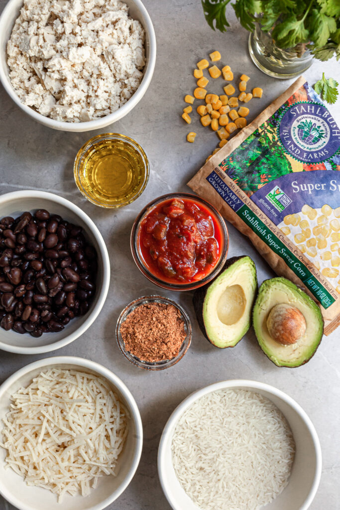 Ingredients for Mexican rice skillet laid out on a marble counter-top