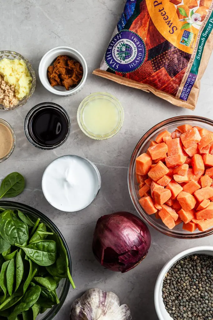 All of the ingredients set out on a marble countertop for the sweet potato lentil curry