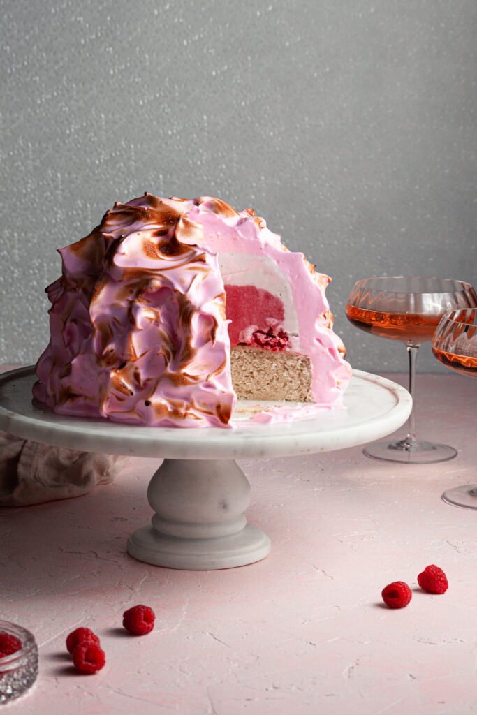 Pink baked alaska with a pink and white ice cream filling