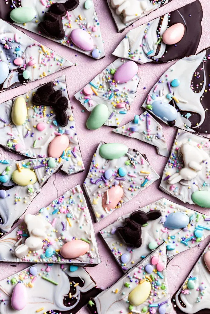 Close up looking down on chocolate bark decorated with chocolate bunnies, Easter eggs and sprinkles