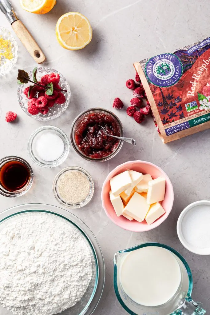 View looking down on a marble counter and the ingredients measured out for the raspberry sweet rolls. 