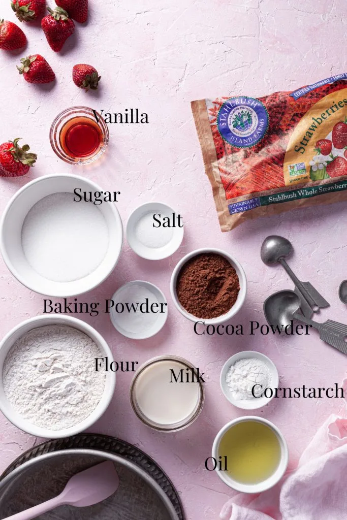 A pink counter is covered in the premeasured ingredients for this self-saucing chocolate strawberry pudding. 