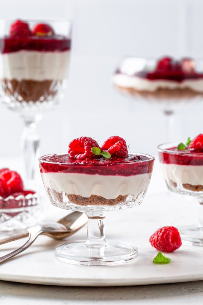 No Bake Dairy Free Cheesecakes serving in coupe glasses and wine glasses.