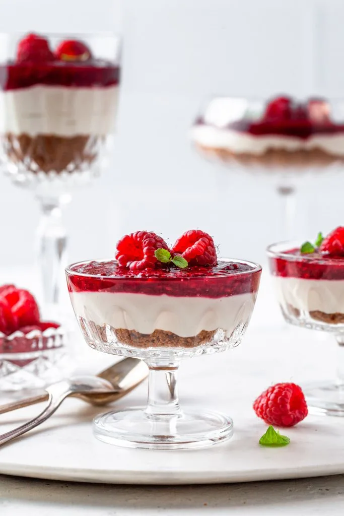 No Bake Dairy Free Cheesecakes serving in coupe glasses and wine glasses.