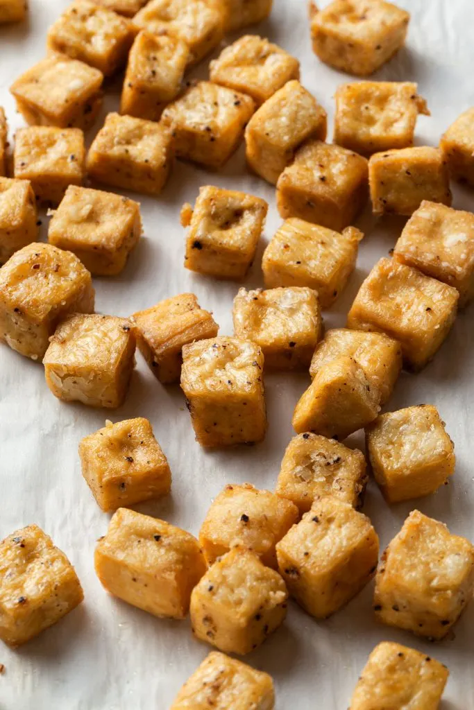 Baked crispy tofu on a sheet pan.