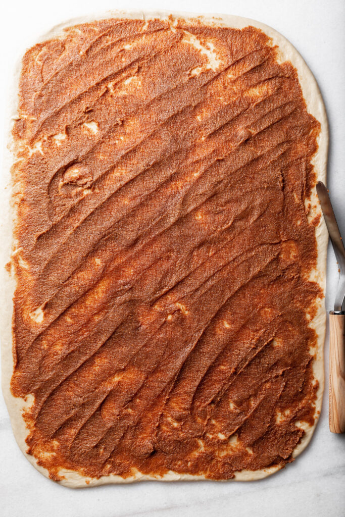 Dough rolled out into a rectangle, and spread with fig paste. 