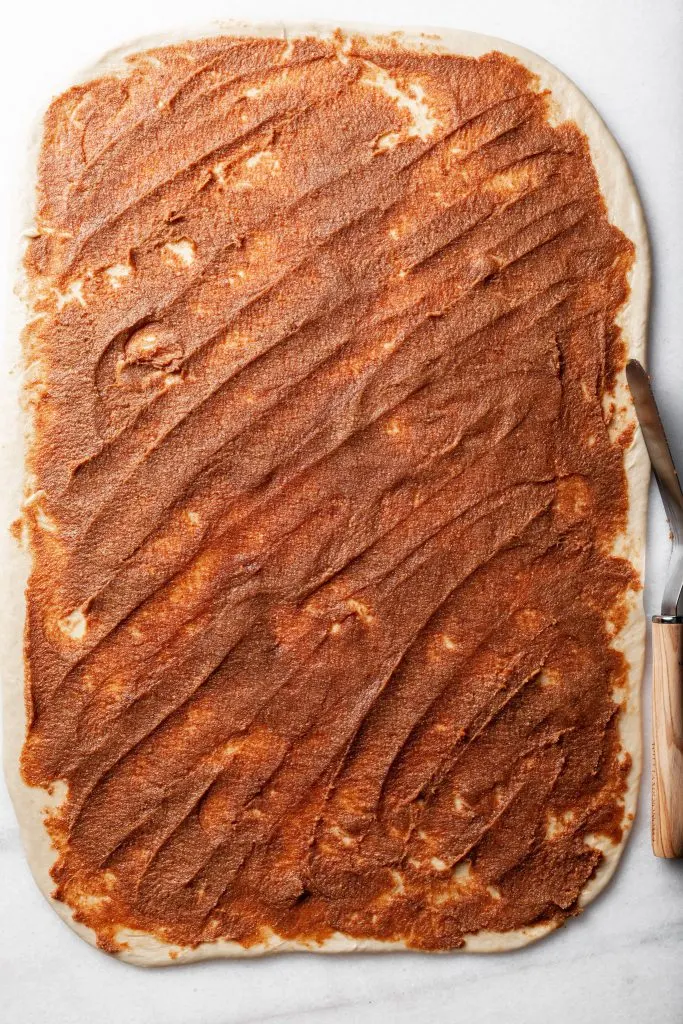 Dough rolled out into a rectangle, and spread with fig paste. 