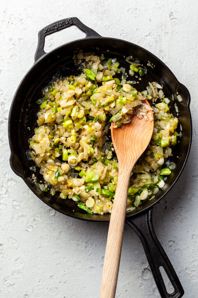 Fried onions, scallions and garlic in a cast iron pan. 