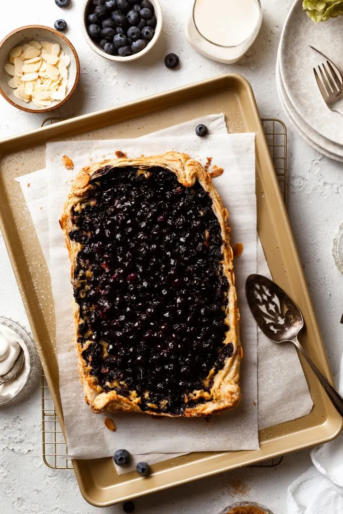 Baked rectangular open faced pie on a baking sheet.